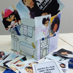 Caixa Cenário do material Amor de Cabelo com 29 cartões ilustrados e molde para atividades interativas.