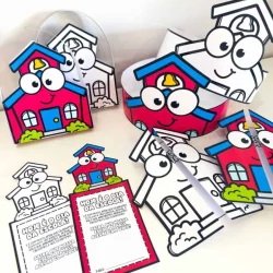 Lembrancinhas de escola em forma de casas com rosto sorridente e olhos grandes.