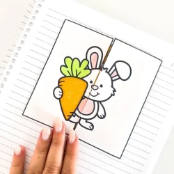Desenho de coelho segurando uma cenoura em uma folha de papel.