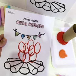 Desenho de fogueira junina com papel e tinta para atividade escolar.