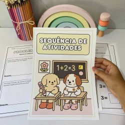 Material de atividades educativas com desenhos de cães e arco-íris.