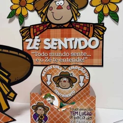 Espantalho Zé Sentido com flores e mensagem sobre emoções.