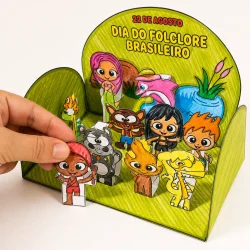 Figuras de papel representando personagens do folclore brasileiro em cenário colorido.